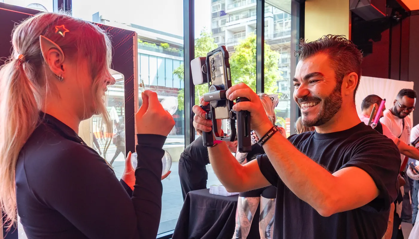 A KRU team member filming content with a shopper in store